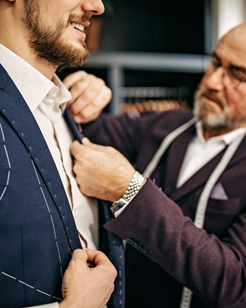 Tailor measuring a suit